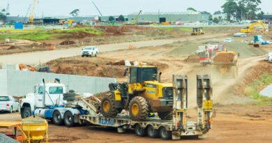 yellow and black heavy equipment on brown field during daytime