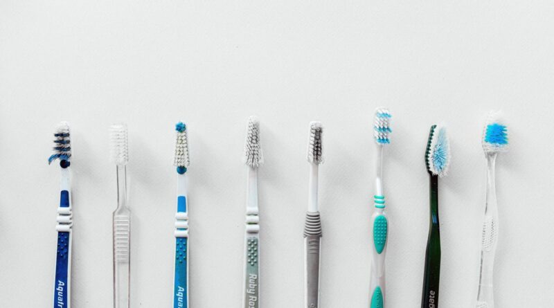 Diverse selection of toothbrushes lined up for dental hygiene focus with copy space.